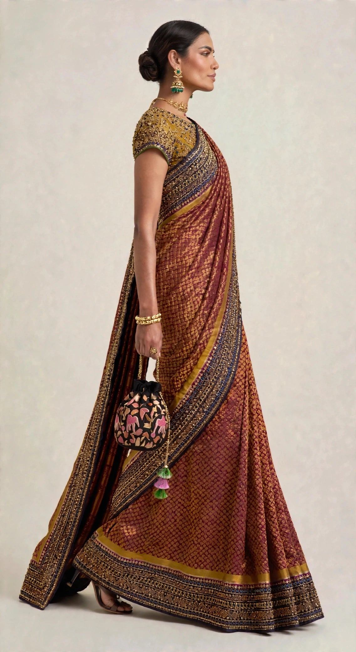 Crimson zari silk saree — standing front view showing full border detail