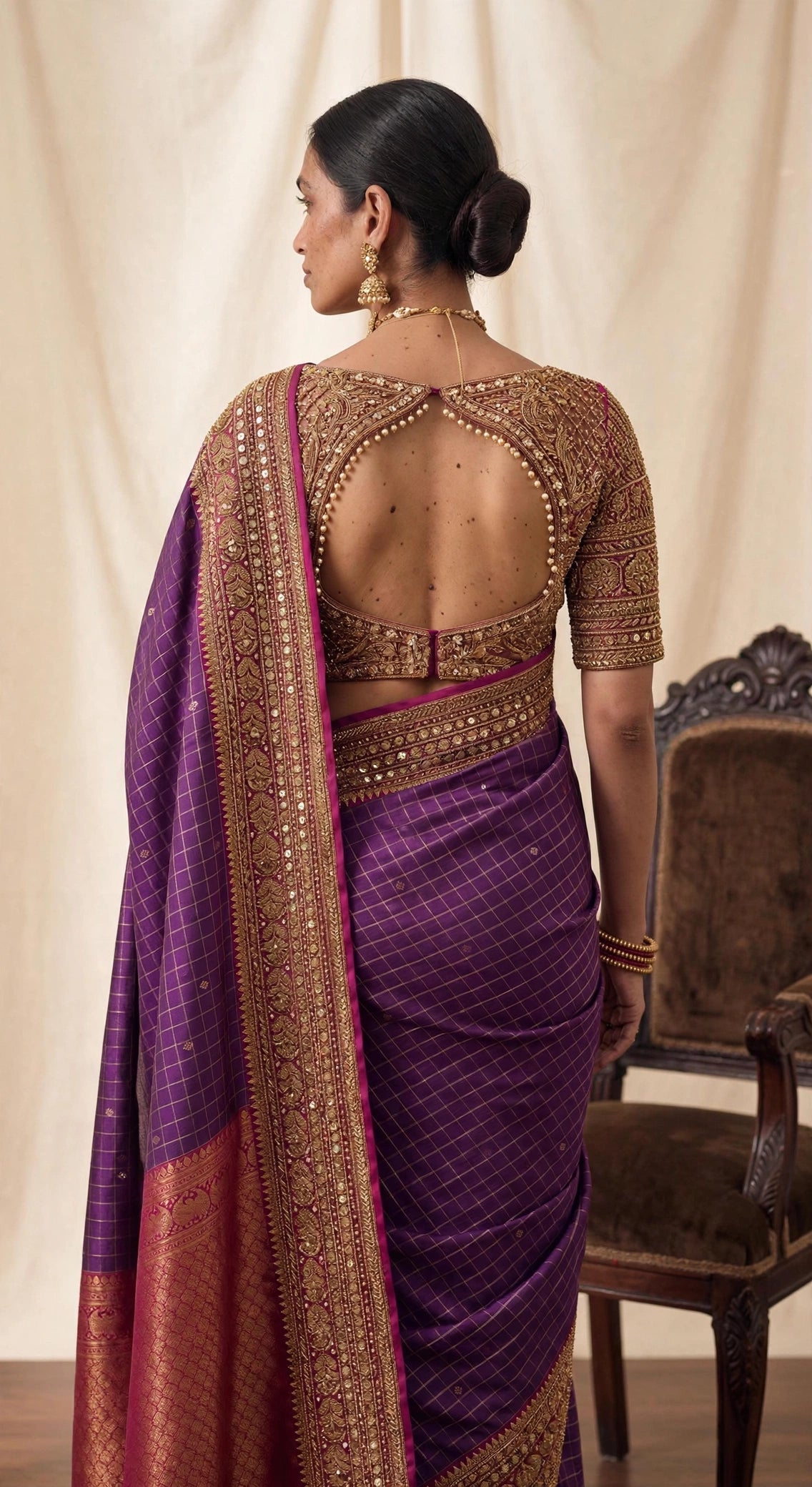 Molkalmuru silk zari saree in amethyst purple - editorial front view with chair