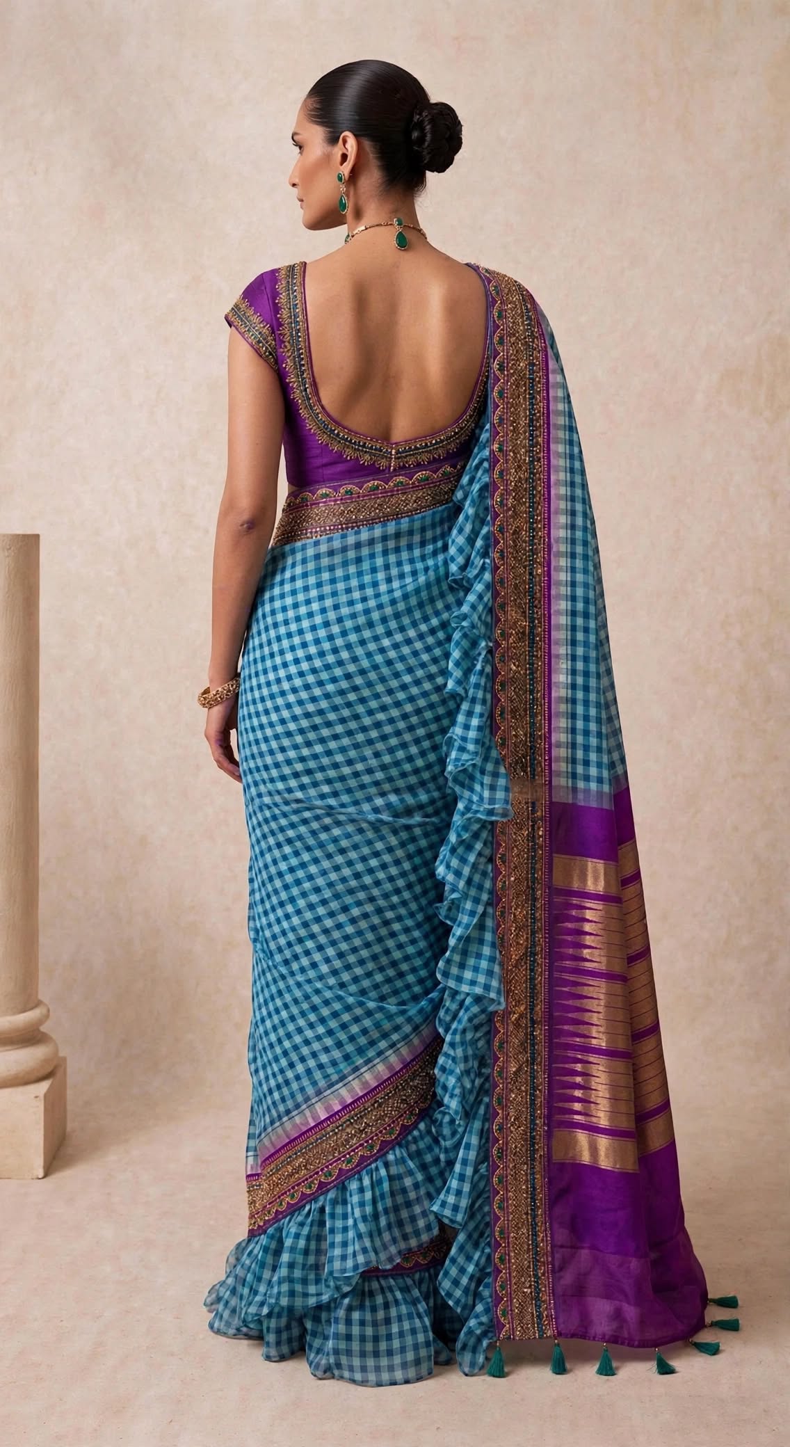 Checks But Make It Cocktail saree — seated side view showing full ruffle skirt and handmade green tassels