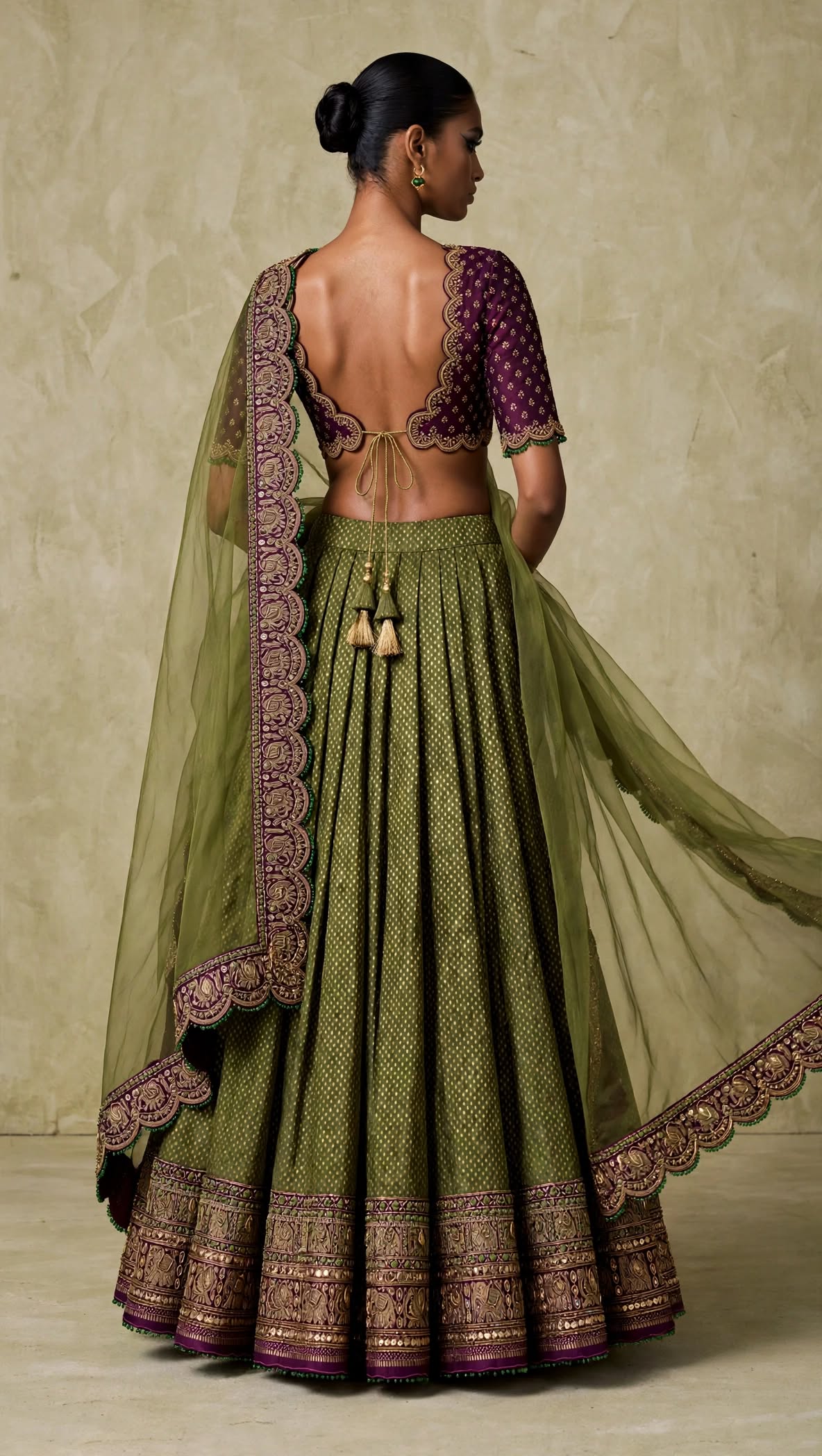 Full back view of olive green lehenga and plum blouse