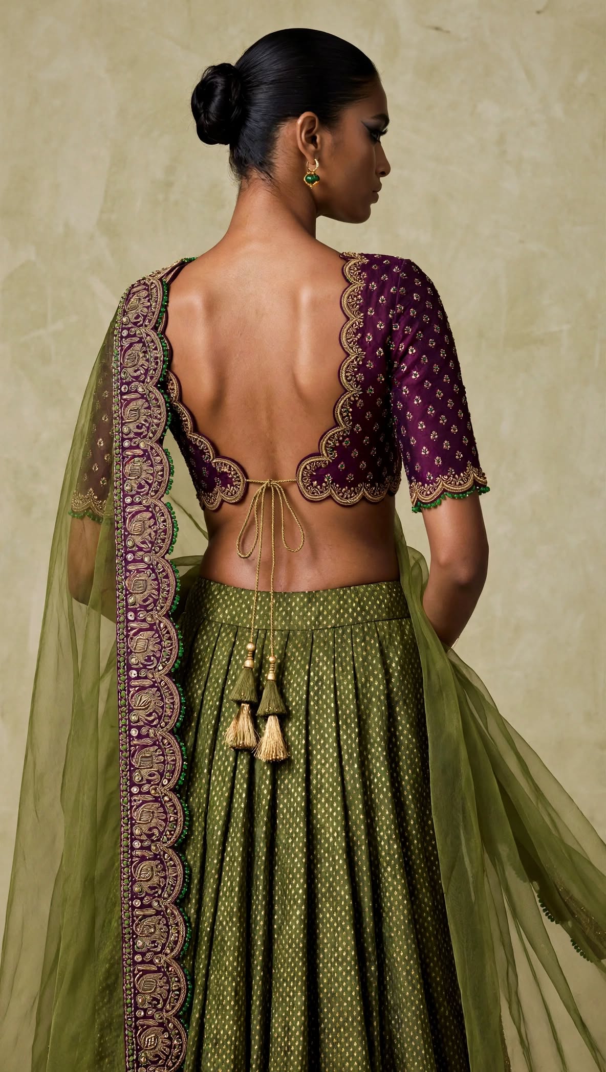 Close-up back view of plum blouse with scalloped neckline and tie tassels